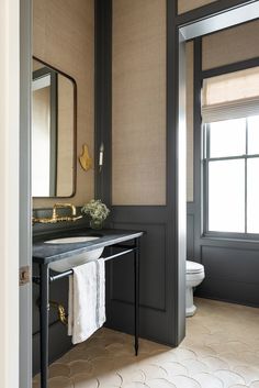 a bathroom with a sink, mirror and toilet