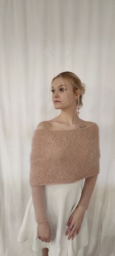 a woman is standing in front of a white backdrop