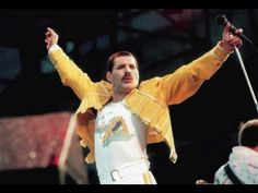 a man in yellow and white outfit holding a microphone