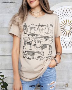 This Unisex jersey short sleeve tee features a wonderful collage of vintage animal skeleton illustrations. It is the perfect gift for wildlife vets, animal conservationists, science teachers and more! Make sure to check out the other garment options below :) » O P T I O N S « ‣ Crewneck: https://www.etsy.com/listing/1041122084 » A B O U T « ‣ This item is made to order using direct-to-garment (DTG) printing technology. This digital process involves the printer inks being jetted or sprayed onto t Clothing Anatomy, Animal Skeleton, Animal Skeletons, Vulture Culture, Vet Med, Animal Bones, Skeleton Shirt, Dtg Printing, Teacher Outfits