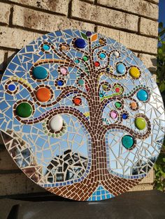 a mosaic tree on the side of a building