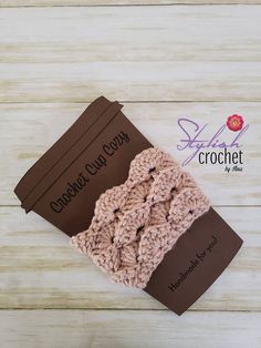 the crocheted headband is made from yarn and has a brown tag on it