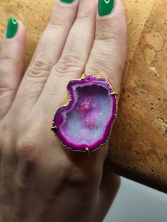 Introducing our stunning Geode Rings - nature's hidden treasures transformed into exquisite jewelry! Each Geode Ring showcases the unique beauty of geodes, with their captivating crystals and vibrant colors. Elevate your style and connect with the Earth's natural wonders. Discover the magic of geodes with our Geode Rings today! 🔸Adjustable band ring  🔸30mm stone size 🔸Color may vary according to lighting 🔸Gold filled We offer  🔸Fast shipping  🔸Free shipping eligible orders 🔸Polishing cloth  🔸Free item for orders above 100€ 🔸Gift box 🎁 🔸Great customer service  Geodes: Nature's hidden gems, revealing breathtaking crystals inside. Adorn yourself with our Geode Rings to capture their natural beauty Unique Open Ring With Raw Stone, Agate Gemstone Open Ring, Agate Gemstone Open Ring Jewelry, Agate Open Ring Jewelry, Unique Round Gemstone Geodes, Unique Crystal Open Ring With Stone Setting, Agate Open Ring Gift, Agate Open Ring For Gift, Promise Ring With Raw Stone Crystal Open Ring