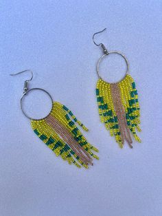 Handwoven seed bead earrings using yellow, green, and gold Czech seed beads. Each bead has been touched by my hand multiple times, a lot of time and energy goes into each piece. Please note that color/tone may differ in person due to monitor brightness and other settings. Green Dangle Beaded Earrings With Gold Beads, Bohemian Green Earrings With Gold Beads, Yellow Adjustable Earrings With Tiny Beads, Adjustable Yellow Earrings With Tiny Beads, Yellow Beaded Earrings With Gold Round Beads, Yellow Gold Beaded Round Earrings, Colorful Beaded Drop Earrings In Yellow, Yellow Beaded Drop Earrings With Colorful Beads, Bohemian Yellow Earrings With Tiny Beads