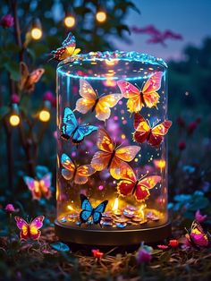 a glass jar filled with butterflies sitting on top of a lush green field covered in flowers