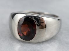 The ultimate 'go with anything' ring, this vintage mounting is low to the hand and has a sleek unisex design, making it comfortable to wear day or night! The polished bezel and inset setting protect the deep, wine-red garnet set in the center.Metal: 14K White GoldGem: Garnet 2.41 CaratsGem Measurements: 9.4 x 7.5 mm, OvalRing Size: 8Marks: “14K” Stamped on the inside band Classic Garnet Rings With Bezel Setting, Formal Garnet Ring With Polished Finish, Classic Garnet Signet Ring For Formal Occasions, Formal Garnet Signet Ring, Classic Garnet Signet Ring For Anniversary, Classic Garnet Jewelry With Polished Finish, Timeless Ruby Ring With Polished Finish For Formal Occasions, Modern Garnet Rings For Formal Occasions, Modern Garnet Rings For Formal Events