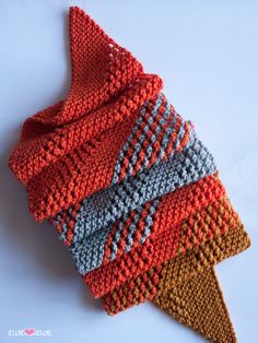 a knitted scarf is laying on top of the other one's headbands