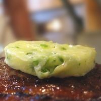 a piece of food that is on top of some kind of meat with broccoli