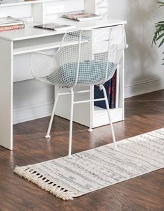 a white desk with a chair next to it and a rug in front of it