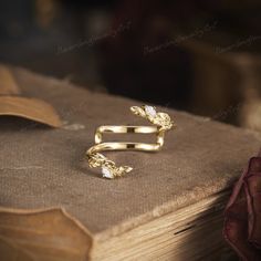 a gold ring sitting on top of a book