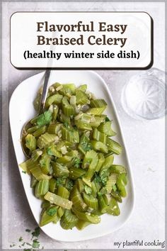 a white plate topped with celery next to a spoon