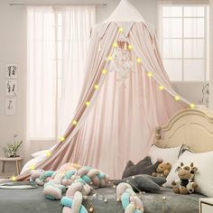 a canopy bed with stuffed animals on it in a child's playroom or bedroom