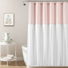 a pink and white shower curtain in a bathroom next to a bathtub with a sink