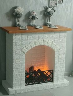 a fireplace with three stuffed animals sitting on top of it