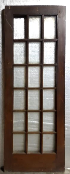 an old wooden window on the side of a wall with glass panes in it