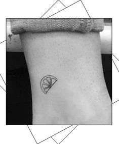 a black and white photo of a small tattoo on the ankle