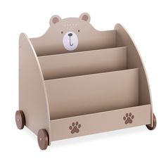 a wooden toy book holder with a bear face on it's head and paw prints