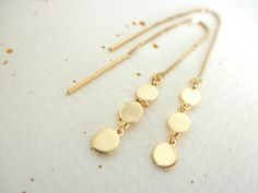 This earrings are very dainty and light to wear.Three teeny tiny gold vermeil discs  charms  connected to a  14K gold-filled box chain ear threader.Discs are 4mm each. Total length is about 4 1/2".--------------------Matching ring:https://www.etsy.com/listing/263451614/disc-chain-double-ring-gold-vermeilMatching necklace:https://www.etsy.com/listing/265619003/mini-gold-disc-necklace-multi-disc-14k--------------------Available on SILVER:https://www.etsy.com/listing/269517816/disc-ear-thread-earri Gold Round Threader Earrings For Everyday, Nickel-free 14k Gold-filled Gold Threader Earrings, Dainty Gold Hypoallergenic Threader Earrings, Gold Nickel-free Threader Earrings, Delicate Gold Hypoallergenic Threader Earrings, Dainty Yellow Gold Threader Earrings, Gold Threader Earrings With Delicate Chain, Delicate Adjustable Gold Threader Earrings, Gold Coin Earrings