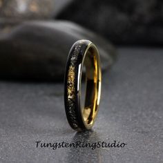 A unique combination of meteorite and gold leaf ring.  The Meteorite and gold leaf was inlaid over the groove of the tungsten setting and finally covered with our protective armor layer that shields it from water, dirt, and grime in order to protect the inlays inside. The rings look great for every day or on your occasions.  Why Choose Us For Your Wedding Ring?  - Rings built to wear 24/7 - No need to maintain, no special instruction - FREE Engraving service - FREE Ring Sizer service - FREE luxu Gold Promise Rings With Natural Inclusions, Black And Gold Mens Wedding Rings, Men's Wedding Ring Black And Gold, Emo Rings, Womens Wedding Rings, Black And Gold Male Wedding Band, Gold And Meteorite Ring, Men’s Meteorite Wedding Ring, Wedding Rings Gold