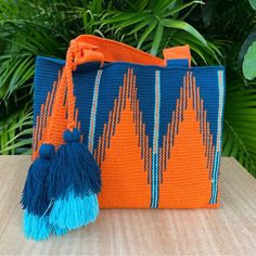 Description: Handwoven Oversized Orange Boho Bag Condition: Brand New! We Designed And Commissioned This Bag And Is Unique Costume Bag That You Will Not Find Anywhere Else. This Special Bag Was Handwoven By Wayuu Woman In Colombia. The Wayuu Are An Indigenous Tribe In Colombia Known For Their Beautiful Handwoven Work, And This Bag Represents About A Week's Worth Of Work. Details: Handmade Item-Handwoven Colors: Orange & Blue Dimensions: 14"W X 11" L Total Length: 20" Style: Hippie/ Bohemian/ Ret Bohemian Blue Rectangular Bucket Bag, Blue Bohemian Beach Bag With Large Capacity, Blue Bohemian Bags With Handles, Handwoven Orange Crochet Bag For Travel, Orange Handwoven Crochet Bag For Travel, Handmade Orange Crochet Bag For Travel, Colorful Handwoven Tote Bag, Blue Bohemian Bag For Shopping, Blue Rectangular Bucket Bag For Vacation