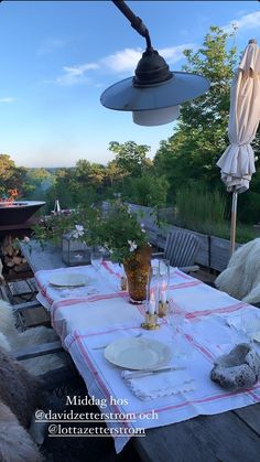 an outdoor dining area with table and chairs