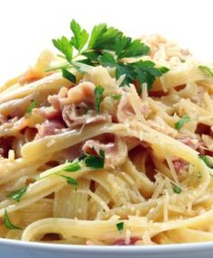 pasta with ham and parsley on white background