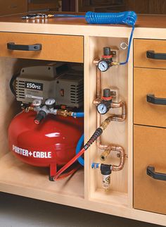 a red fire hydrant sitting inside of a cabinet