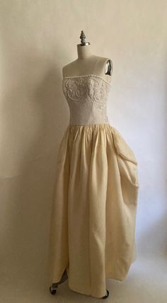 1980s gorgeous Carolina Herrera form fitting beaded gown with cream silk skirt. Strapless bodice has boning  and is lined in white silk; zips up the back with a hook and eye to finish the closure. Silk skirt is gathered at the hip for volume and skirt is fully lined in white silk. Dress is in very good vintage condition. There is one small light gray spot in the back of the dress about an inch long. Dress has been cleaned. Chest 34-36" Waist 28" Hips-open Length from top of chest to hem  52" Vin Silk Cream Evening Dress With Fitted Bodice, Vintage Corset Wedding Dress With Lined Bodice, Cream Fitted Bodice Evening Dress For Gala, Vintage Wedding Corset Dress With Lined Bodice, Cream Corset Dress With Fitted Bodice For Evening, Silk Wedding Corset Dress With Lined Bodice, Elegant Strapless Dresses For Vintage Events, Cream Corset Dress With Boned Bodice For Evening, Cream Strapless Corset Dress For Wedding