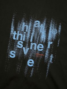 the back of a black t - shirt with blue and white paint splattered on it