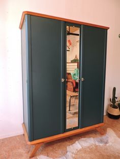 an armoire in the corner of a room