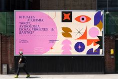 a man walking past a large advertisement on the side of a building