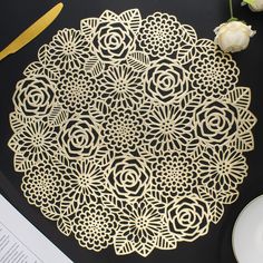 an intricately designed doily sits on a table