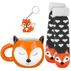 a mug, socks and keychain with a fox head on it's side