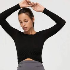 For A Little Extra Coverage. A Black Cropped Workout Top With A Round Neckline, Cross-Front Design And Long Sleeves. Made With Soft Brushed Fabric To Minimize Chafing, Sweat-Wicking Technology For Added Breathability, And Four-Way Stretch For Ultimate Comfort. Pair With Your Favorite High-Waisted Leggings. Four-Way Stretch Light Weight Sweat-Wicking & Fast-Drying Care Instruction: Hand Wash Separately And Gently In Cold Water. Line Flat Separately To Dry. Do Not Bleach. Do Not Tumble Dry. Do Not Black Workout Tops For Fall, Versatile Black Crew Neck Crop Top, Black Stretch Crop Top For Layering, Black Long Sleeve Crop Top For Workout, Versatile Black Stretch Crop Top, Black Fitted Yoga Top, Fitted Black Yoga Top, Black Yoga Tops For Fall, Chic Black Tops For Yoga