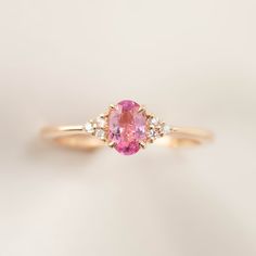 * ≈6x4mm Pink tourmaline * Side stones : White diamonds G color SI1 0.06ctw * Band width: ≈1.4mm Tapered band * 14k solid rose gold * Made of 100% recycled solid14k gold metal and ethically sourced gemstones Ring Size This ring is currently size 7, and can be resized 3~8.5 in 10 days. For other ring size, it is going to be a custom order. Please email cs@enverojewelry.com. Custom Order This ring can be made in any size, any material and different gemstone. For full details of semi-custom order, Diamond Ring Oval, Pink Engagement, Outfit Polyvore, Dainty Engagement Rings, Pink Diamond Ring, 27 Dresses, Sapphire Earrings Studs, Pink Tourmaline Ring, Unique Engagement Ring