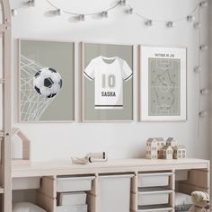 three framed pictures hang on the wall in a child's room with toys and decor