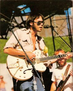 a man playing an electric guitar on stage