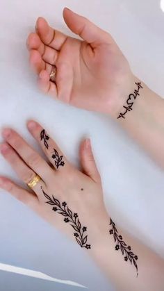 two hands with tattoos on them and one has a flower tattoo on the left hand