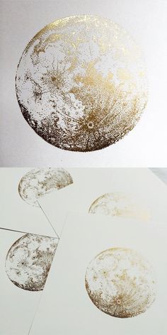 an abstract painting with gold paint on white paper and some circles in the air above it