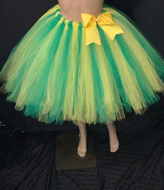 Beautiful Multi-Colored Multi-Layered Tutu. Inspired by the Beautiful Colors of Spring & Summer Blooms. Handmade from 100% Polyester. Soft, Comfortable 1 inch Elastic Waistband. Lightweight and fun to wear. Can be Used as Casual or Formal Wear. Yellow Tutu Dress With Tulle Skirt For Spring, Fitted Green Petticoat For Spring, Fitted Green Petticoat For Summer, Green Tulle Tutu Dress For Party, Summer Party Green Petticoat, Spring Yellow Tutu Dress With Tulle Skirt, Green Summer Party Petticoat, Green Spring Tutu Dress For Birthday, Spring Green Tutu Dress For Birthday