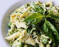 a white bowl filled with pasta and vegetables