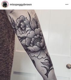 a person with a flower tattoo on their arm