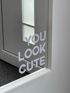 the words you look cute are cut out of an office door