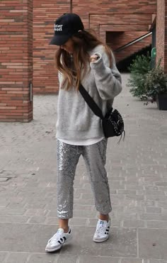 Sequin Trousers Street Style, Sequin Joggers With Sneakers, Grey Sequin Pants Outfit, Silver Trousers Outfits Street Styles, How To Style Silver Sequin Pants, Silver Sequin Shorts Outfit, Silver Pants Outfit Winter, Sequin Black Pants Outfit, Dress Pants And Sneakers Outfit