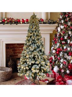 two christmas trees in front of a fireplace