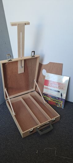 an open wooden box sitting on top of a carpeted floor