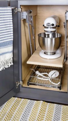 an open cabinet with a mixer and other kitchen accessories