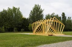 a wooden structure sitting on top of a lush green field