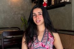 a woman sitting at a table in a restaurant