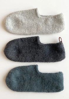 three pairs of knitted mittens sitting next to each other